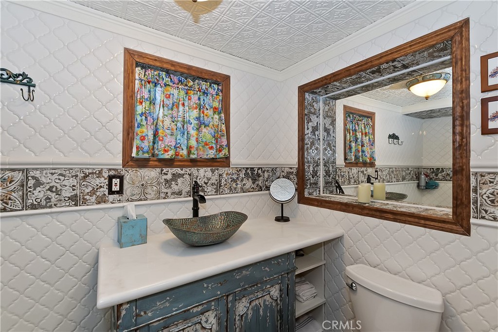 329 Summit Road Lake Arrowhead, CA 92352 - Photo 48 of 61 a bathroom with a sink a mirror and a toilet