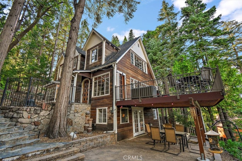 329 Summit Road Lake Arrowhead, CA 92352 - Photo 50 of 61 a view of a wooden chairs and table in the patio