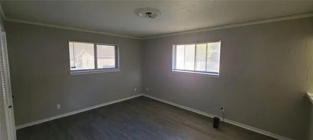 a room with a wooden floor and furniture
