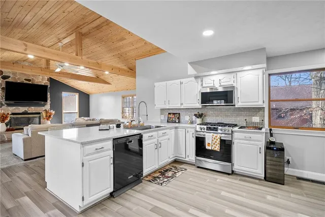 a kitchen with cabinets a sink and appliances