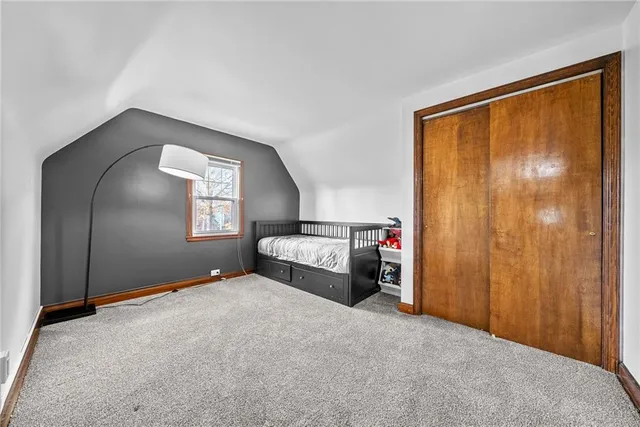 a bedroom with a bed and a mirror