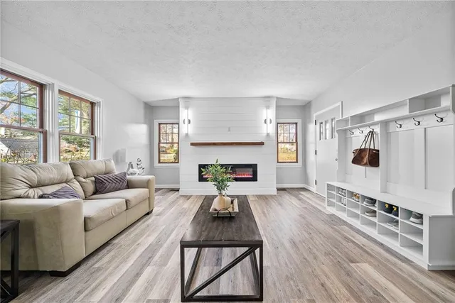 a living room with furniture a window and a fireplace