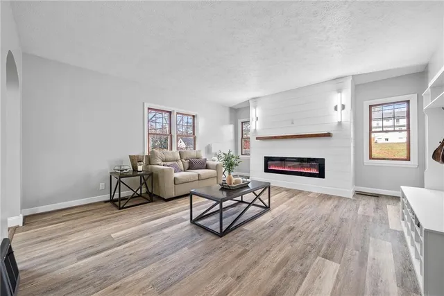 a living room with furniture and a fireplace