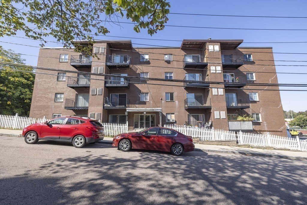 175 Clare Avenue, Unit E8 Boston, MA 02136 - Photo 14 of 16 a cars parked in front of a building
