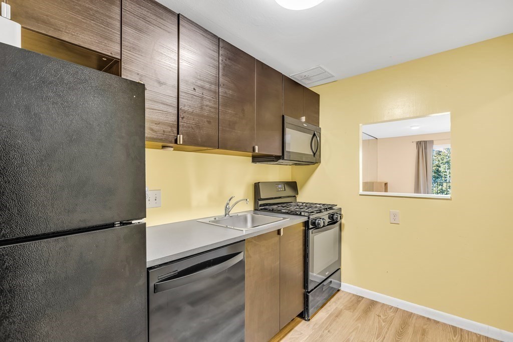 175 Clare Avenue, Unit E8 Boston, MA 02136 - Photo 5 of 16 a kitchen with a stove and a refrigerator
