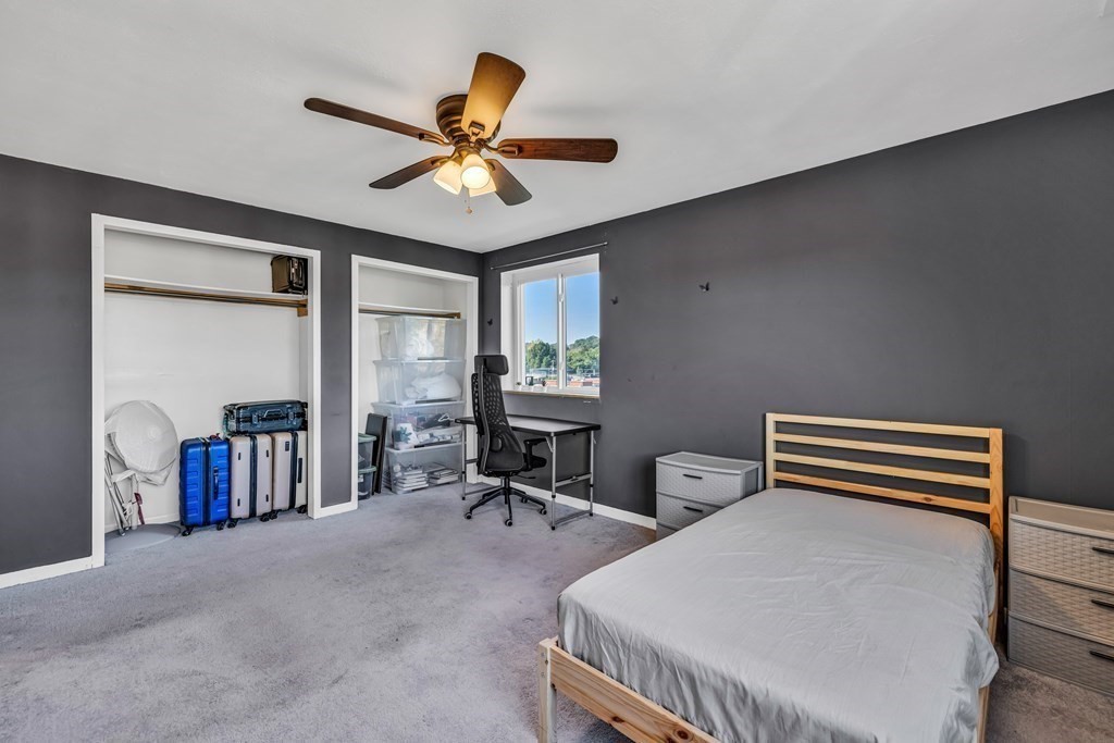 175 Clare Avenue, Unit E8 Boston, MA 02136 - Photo 10 of 16 a bedroom with furniture and a ceiling fan