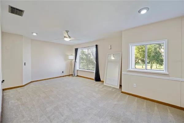 an empty room with windows and closet