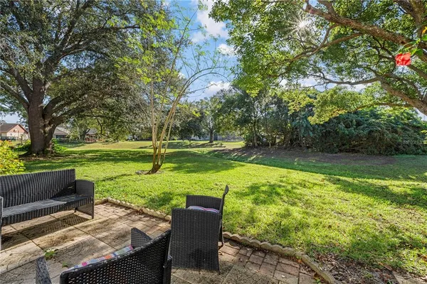 an aerial view of house with yard and outdoor seating