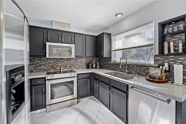 a kitchen with a sink stove and microwave