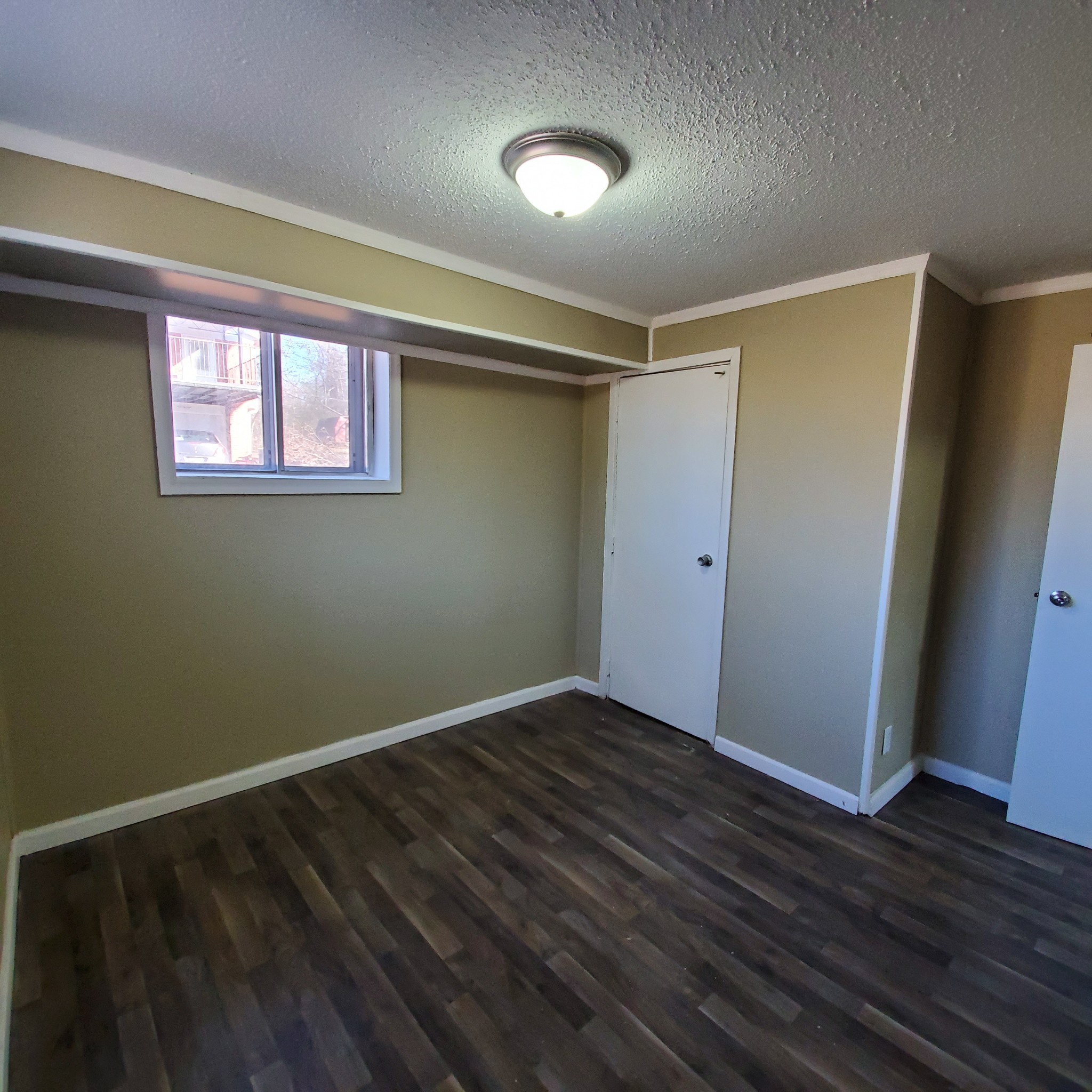108 Airport Road Clarksville, TN 37042 - Photo 12 of 16 a view of an empty room with wooden floor and a window