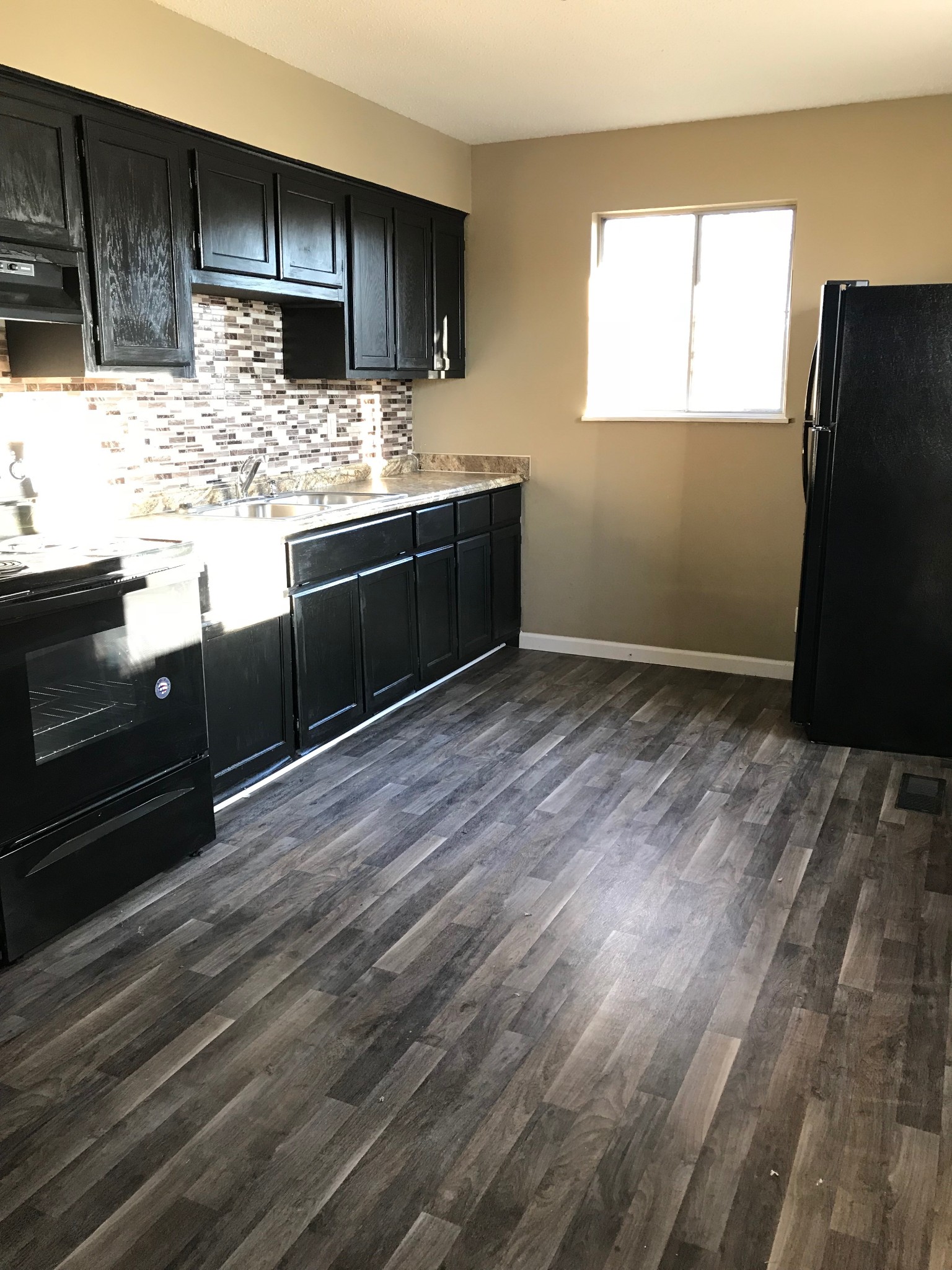 108 Airport Road Clarksville, TN 37042 - Photo 5 of 16 a kitchen with stainless steel appliances kitchen island granite countertop a refrigerator and a sink