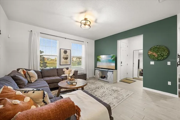 a living room with furniture and a large window