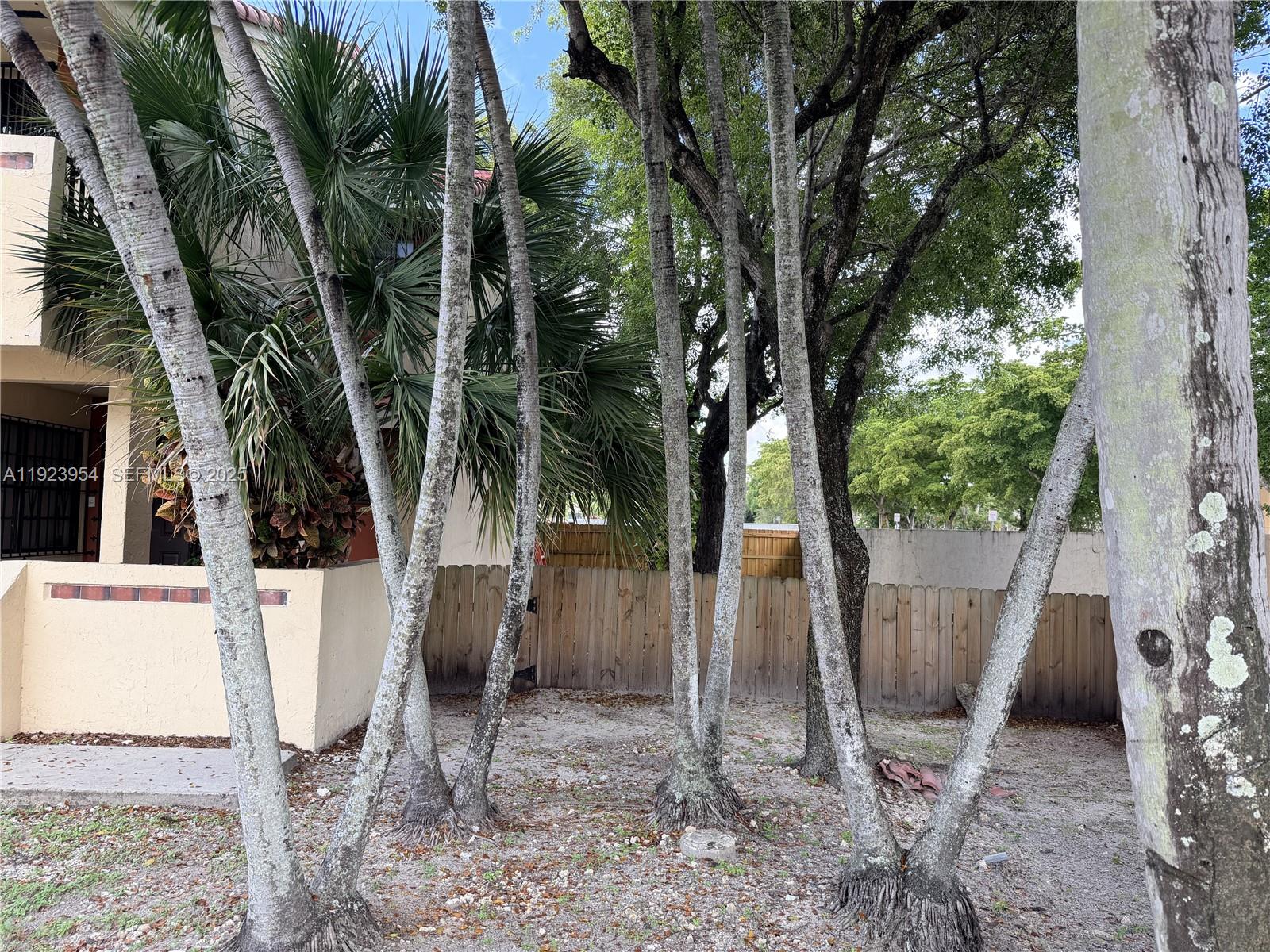 17982 Northwest 68th Avenue, Unit 11C Hialeah, FL 33015 - Photo 4 of 5 a view of a yard with a tree