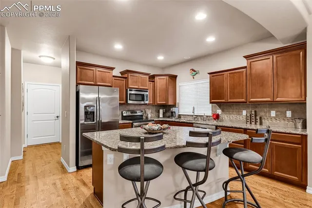 a kitchen with granite countertop sink cabinets and stainless steel appliances