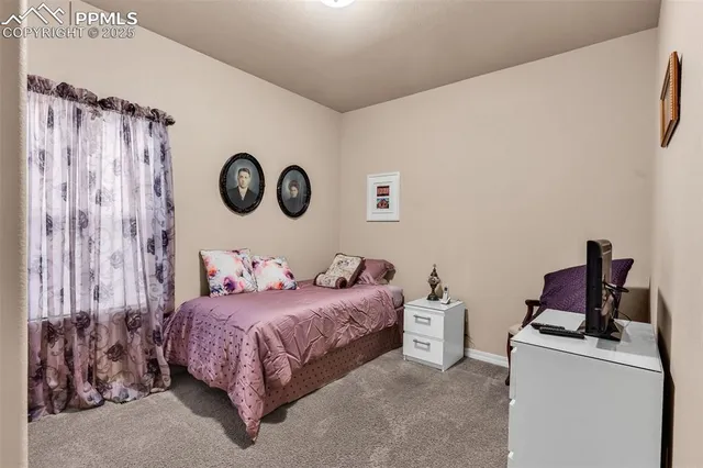 a bedroom with a bed and a clock on the wall