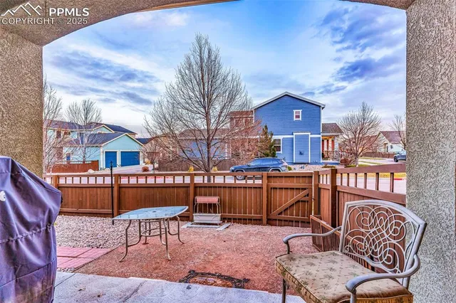 a view of a chairs and table in the patio