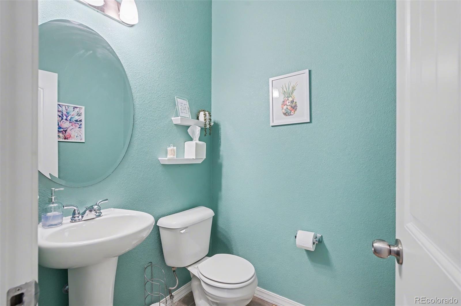 8271 White Fish Way Colorado Springs, CO 80908 - Photo 13 of 47 a bathroom with a toilet sink and mirror