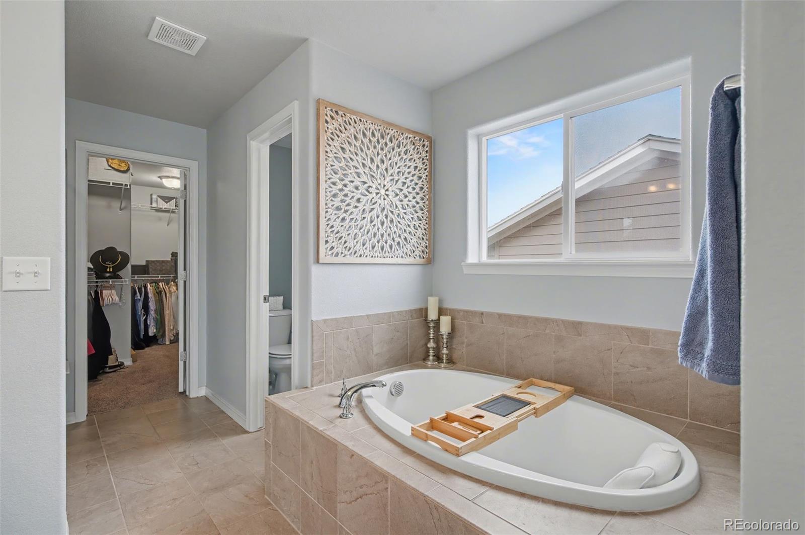 8271 White Fish Way Colorado Springs, CO 80908 - Photo 20 of 47 a bath tub sitting in a bathroom next to a window