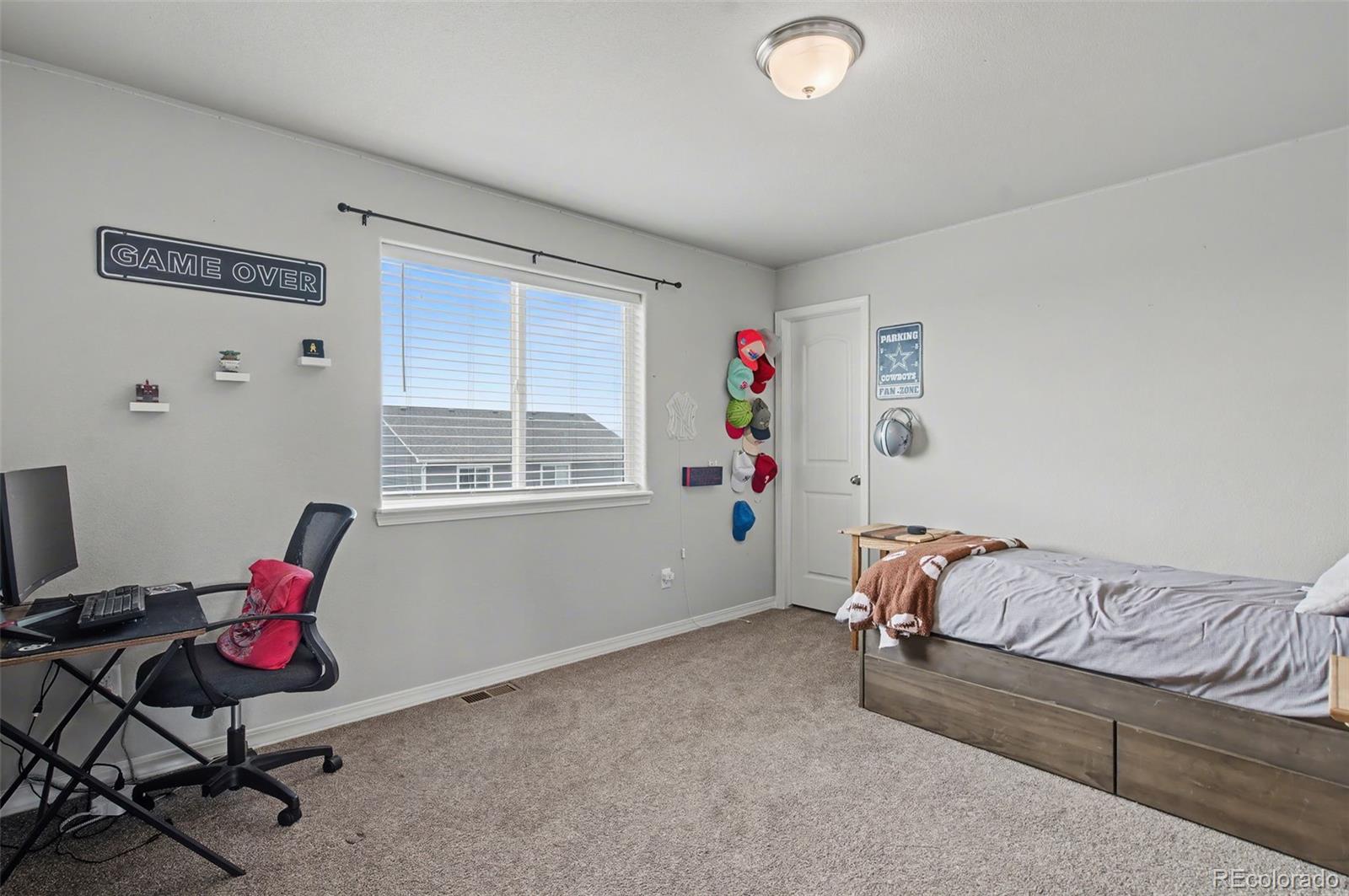 8271 White Fish Way Colorado Springs, CO 80908 - Photo 22 of 47 a bedroom with furniture and a window