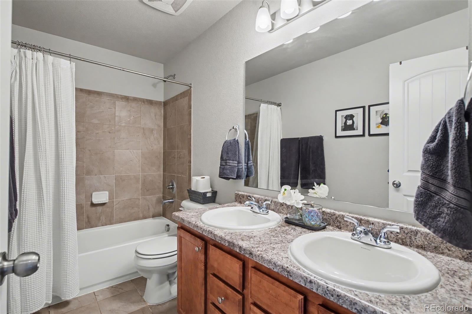 8271 White Fish Way Colorado Springs, CO 80908 - Photo 23 of 47 a bathroom with a granite countertop sink toilet and shower