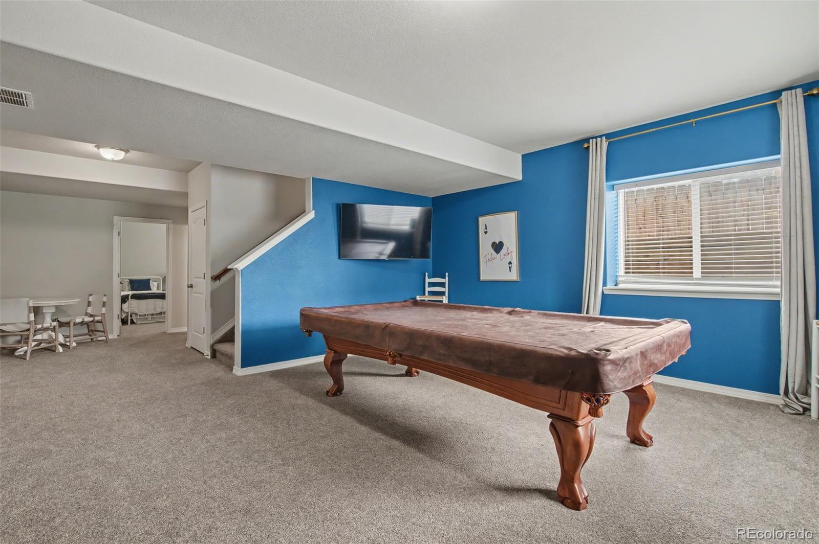 8271 White Fish Way Colorado Springs, CO 80908 - Photo 26 of 47 a bed sitting in a room next to a window