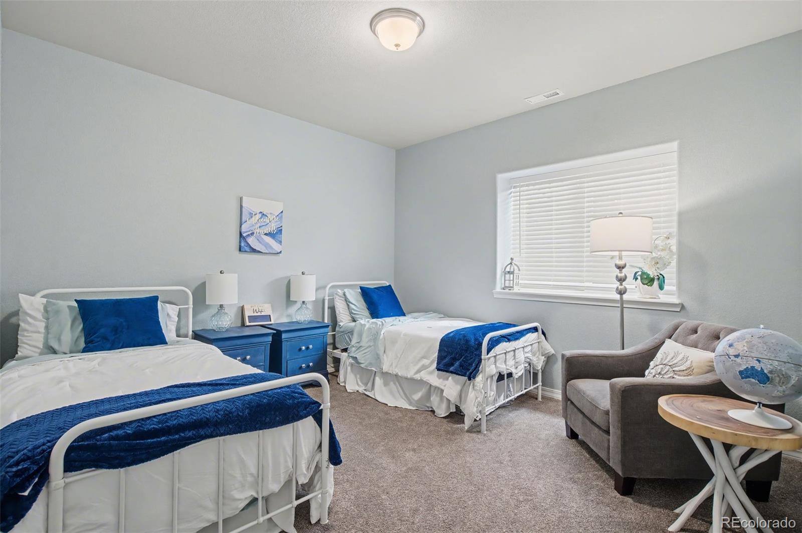 8271 White Fish Way Colorado Springs, CO 80908 - Photo 30 of 47 a bedroom with two beds and a window
