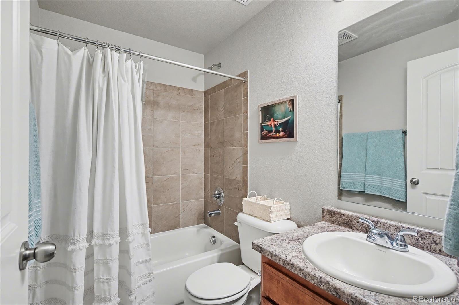 8271 White Fish Way Colorado Springs, CO 80908 - Photo 31 of 47 a bathroom with a sink toilet and shower