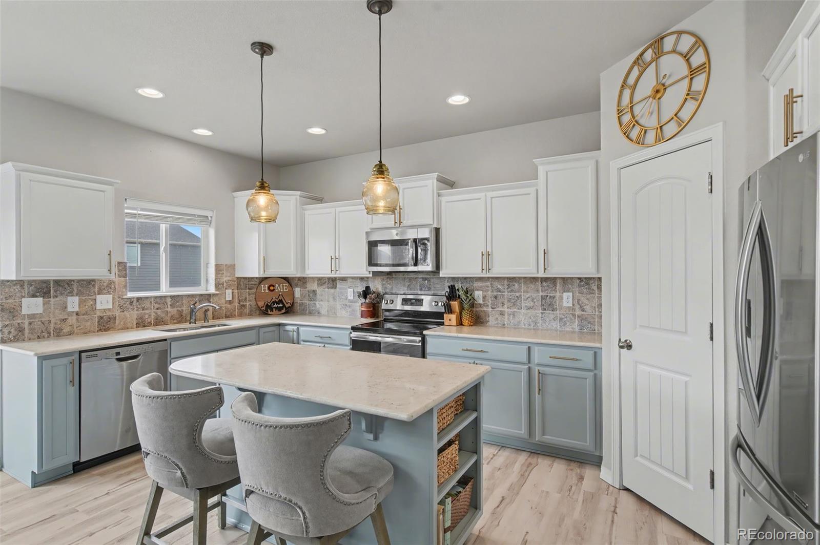 8271 White Fish Way Colorado Springs, CO 80908 - Photo 10 of 47 a kitchen with a sink a counter space stainless steel appliances and cabinets