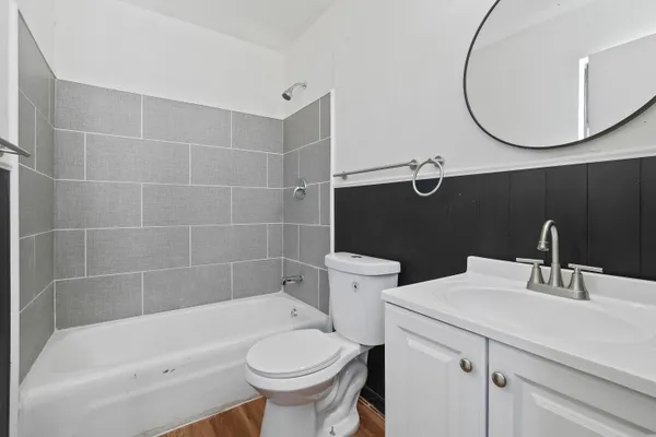 a bathroom with a sink a toilet and bathtub