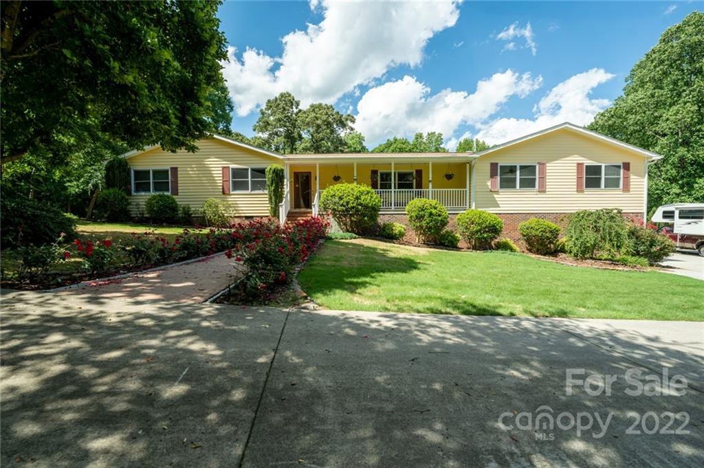 7720 Kinross Drive Oak Ridge, NC 27310 - Photo 1 of 42 a front view of a house with garden