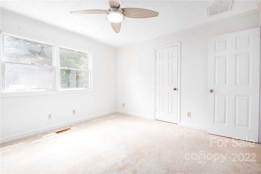 7720 Kinross Drive Oak Ridge, NC 27310 - Photo 17 of 42 a view of an empty room with a window