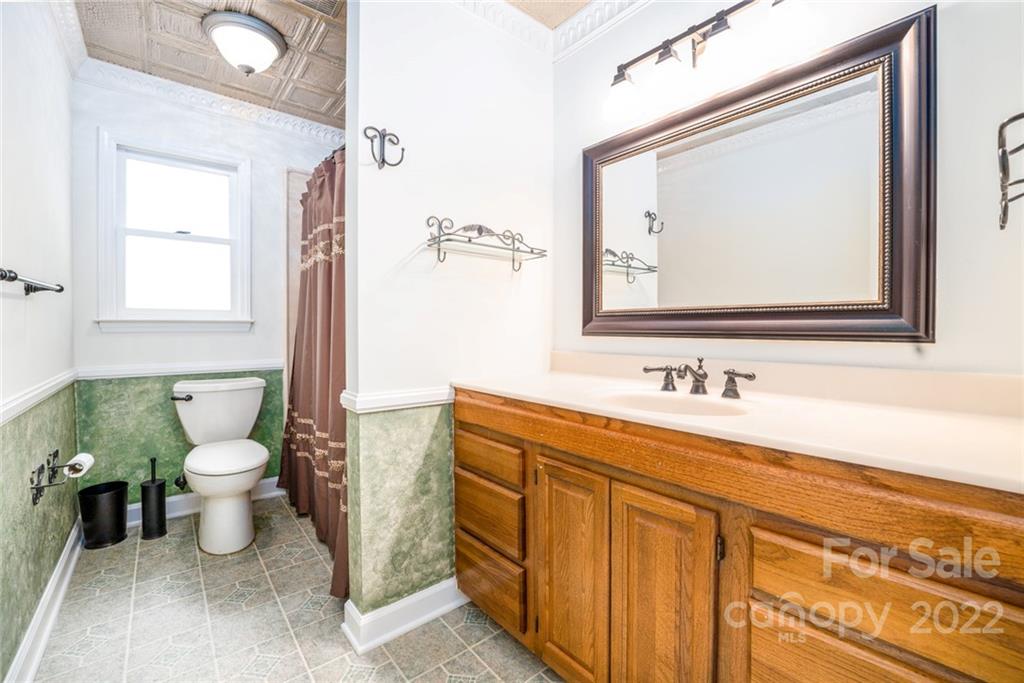 7720 Kinross Drive Oak Ridge, NC 27310 - Photo 20 of 42 a bathroom with a toilet sink and mirror
