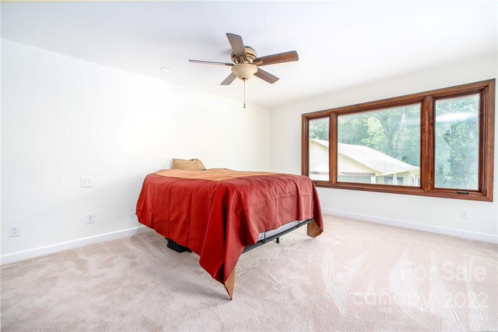 7720 Kinross Drive Oak Ridge, NC 27310 - Photo 22 of 42 a bed sitting in a room next to a window