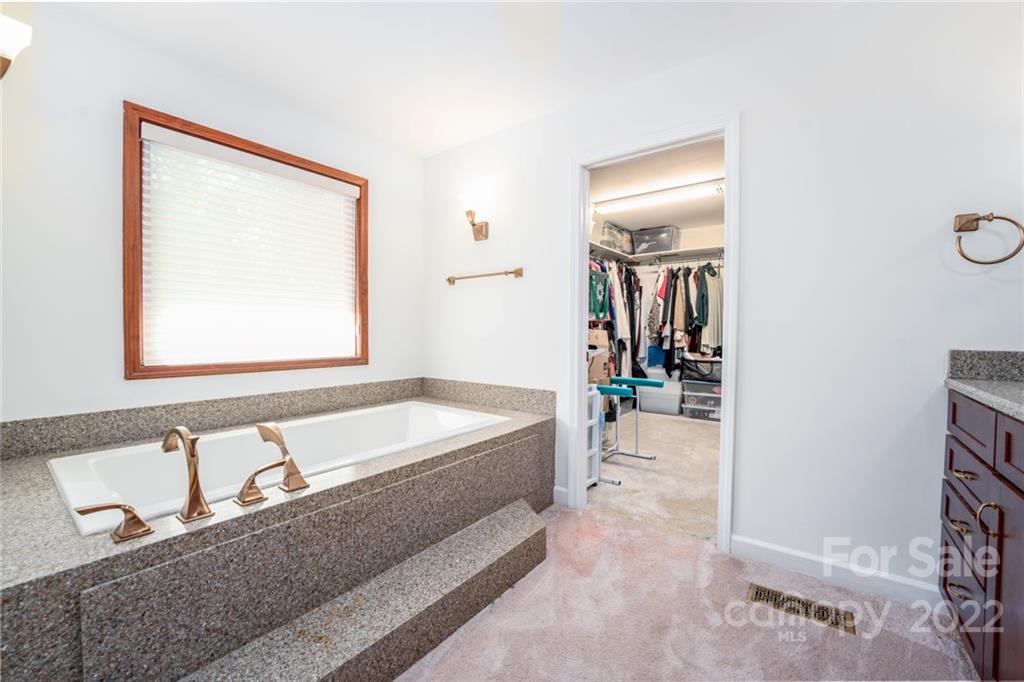 7720 Kinross Drive Oak Ridge, NC 27310 - Photo 25 of 42 a spacious bathroom with a tub and a sink