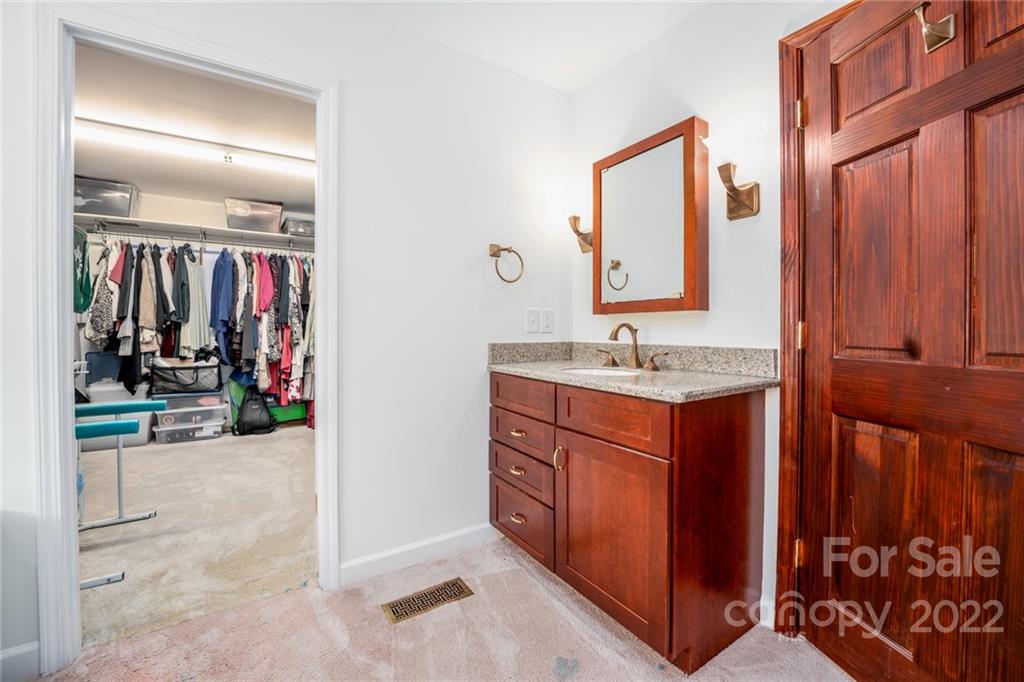 7720 Kinross Drive Oak Ridge, NC 27310 - Photo 26 of 42 a bathroom with a sink vanity and a mirror