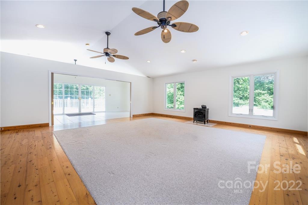 7720 Kinross Drive Oak Ridge, NC 27310 - Photo 28 of 42 an empty room with windows and ceiling fan