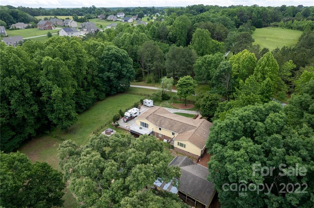 7720 Kinross Drive Oak Ridge, NC 27310 - Photo 37 of 42 an aerial view of a house with a yard and lake view