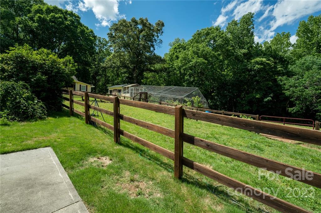 7720 Kinross Drive Oak Ridge, NC 27310 - Photo 6 of 42 a view of a yard with wooden fence