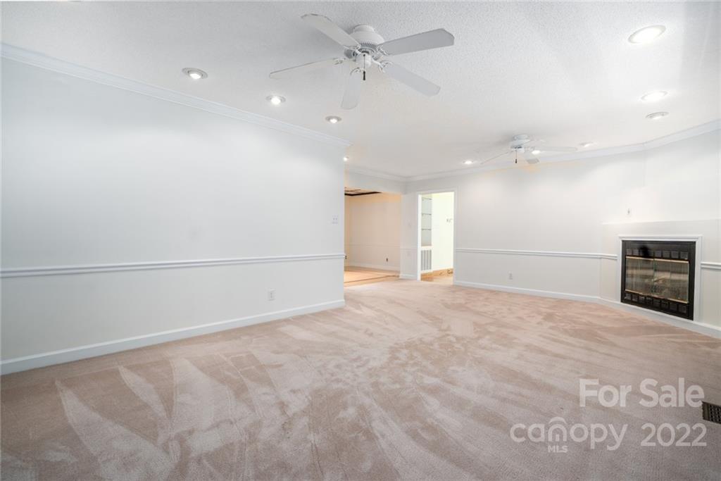 7720 Kinross Drive Oak Ridge, NC 27310 - Photo 10 of 42 a view of an empty room with a fireplace