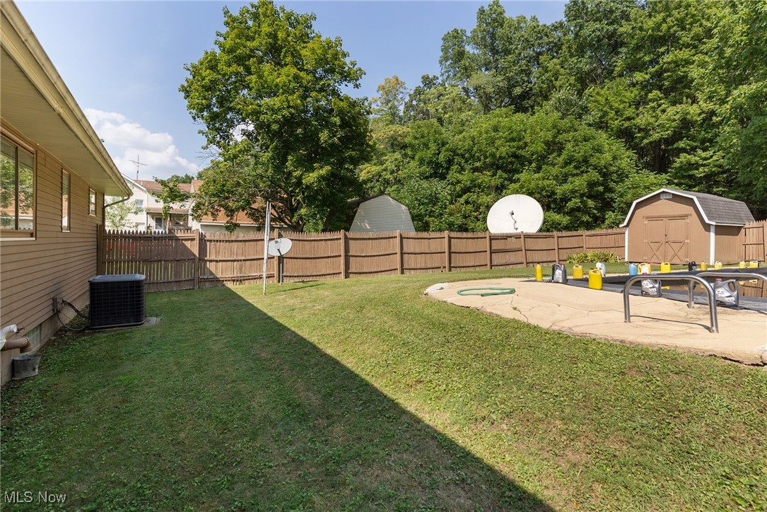 3907 Edwards Street Mineral Ridge, OH 44440 - Photo 38 of 45 Fenced backyard with a shed and a patio