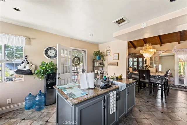 a room with furniture and view of kitchen
