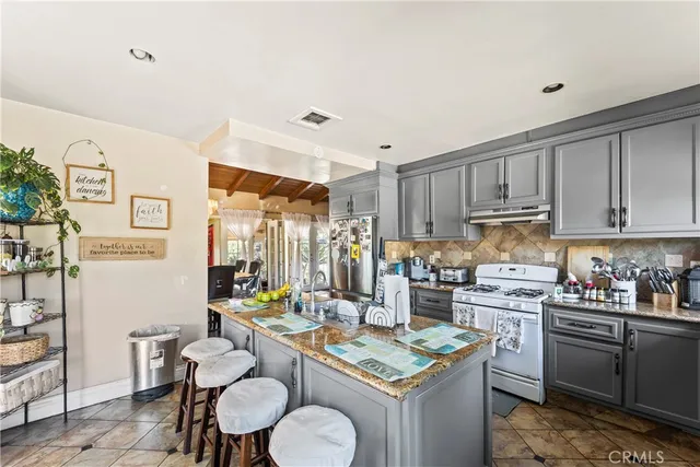 a kitchen with granite countertop lots of counter top space and dining table