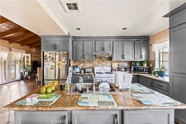 a kitchen with lots of counter top space and appliances