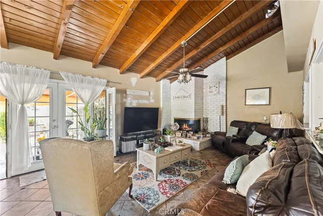 a living room with furniture a flat screen tv and a large window