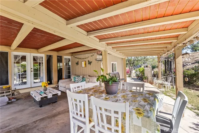 a view of a dining room with furniture large windows and plants
