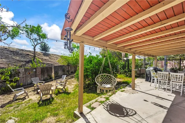 a view of a patio with a dining table and chairs with wooden floor