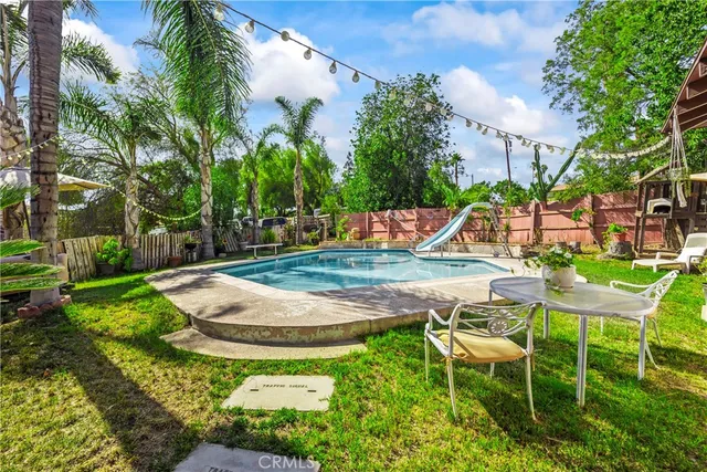 a swimming pool with outdoor seating and yard