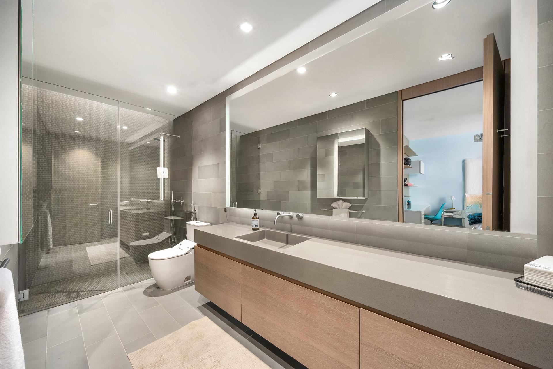 49 Chambers Street, Unit PHB Manhattan, NY 10007 - Photo 11 of 35 a bathroom with a double vanity sink toilet and a mirror