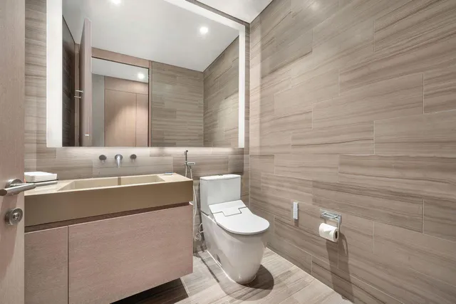 a view of room with walk in closet and wooden floor