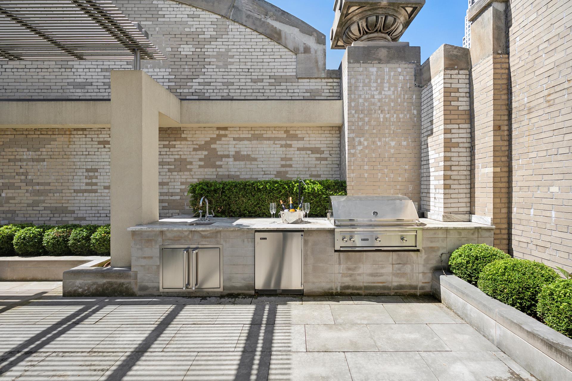 49 Chambers Street, Unit PHB Manhattan, NY 10007 - Photo 17 of 35 a view of a patio with couches and table with potted plants